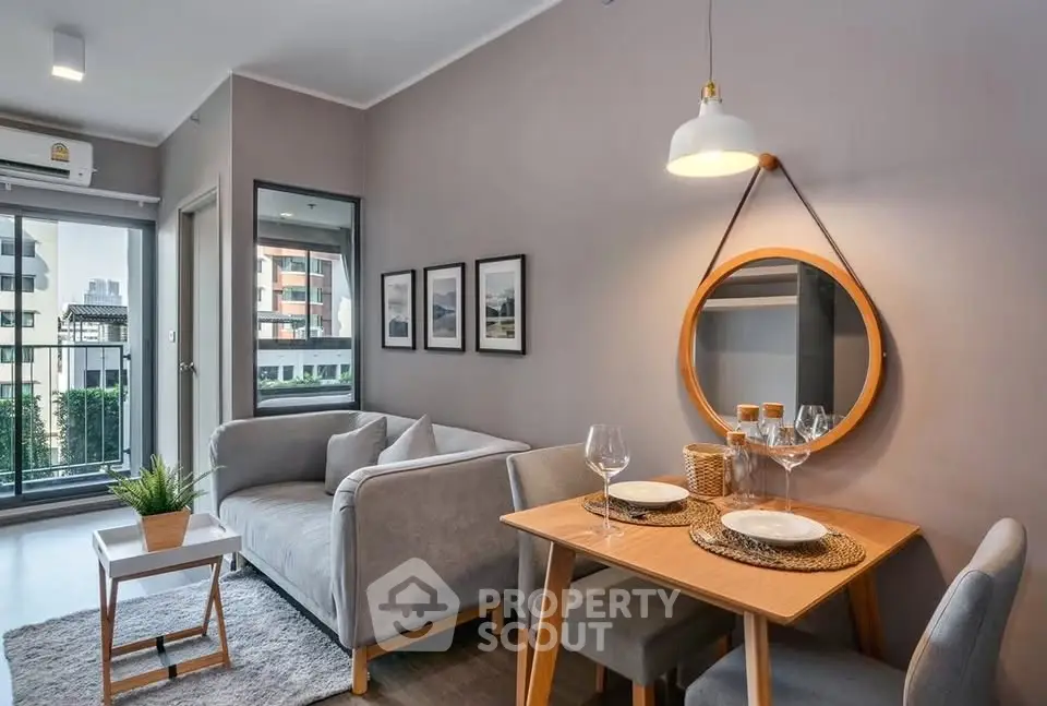 Modern living room with cozy dining area and stylish decor in urban apartment.