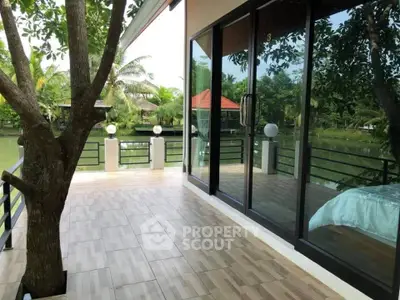 Spacious balcony with serene water view and lush greenery, perfect for relaxation and outdoor enjoyment.