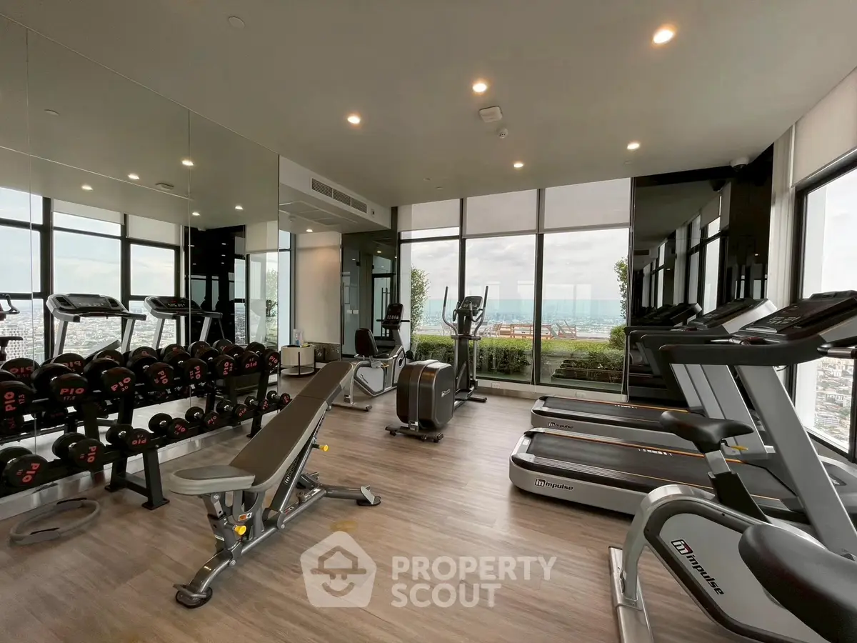 Modern gym with city view and state-of-the-art equipment