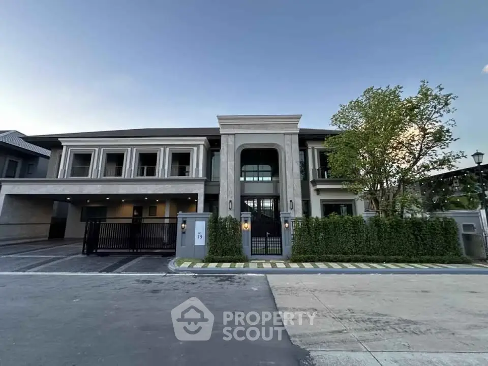 Luxurious modern mansion with grand entrance and lush landscaping