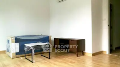 Spacious unfurnished living room with wooden flooring and modern furniture setup.