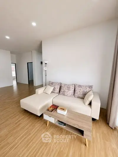 Spacious modern living room with elegant sofa and wooden flooring