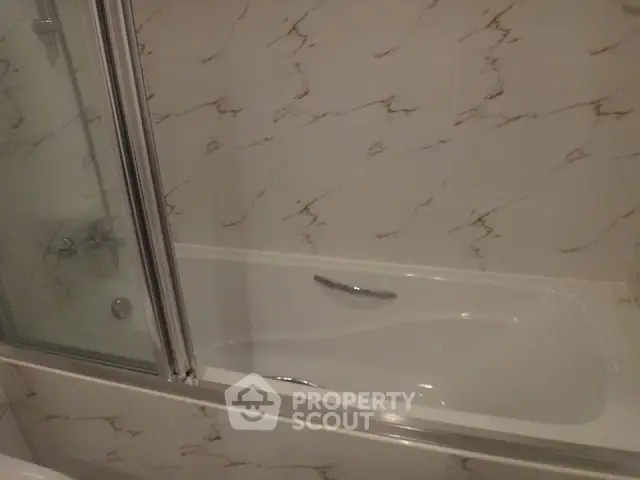 Elegant bathroom with marble tiles and modern bathtub