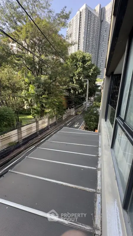 Urban view from building window overlooking street and greenery