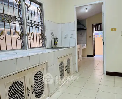 Spacious kitchen with tiled countertops and open layout