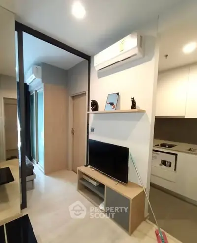 Modern living room with sleek design and integrated kitchen appliances