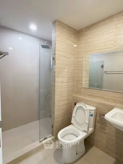 Modern bathroom with glass shower and sleek tile design