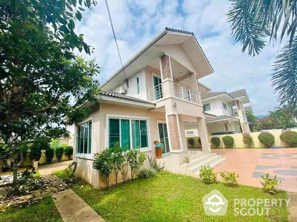 Charming two-story house with lush garden and spacious driveway in serene neighborhood.