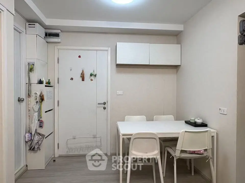 Cozy dining area with modern white furniture and minimalist decor