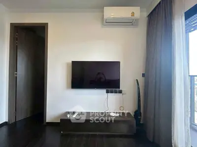 Modern living room with wall-mounted TV and balcony view