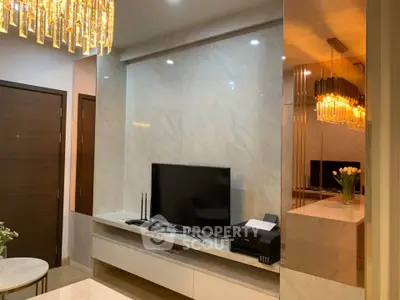 Luxurious living room with modern decor and elegant lighting, featuring a sleek TV setup and stylish furnishings.