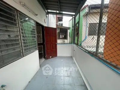 Spacious balcony with secure fencing and tiled flooring in urban setting
