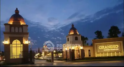 Luxurious grand entrance of a prestigious residential complex at dusk.
