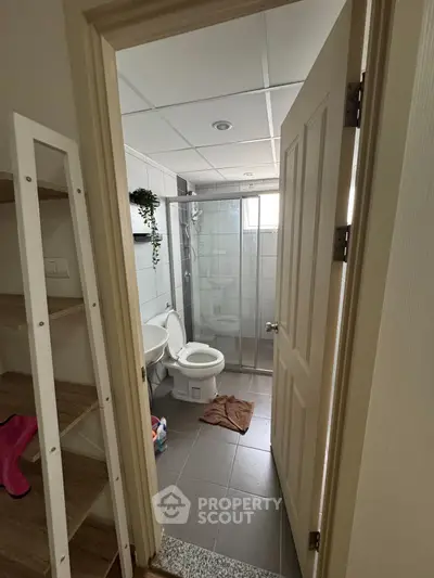 Modern bathroom with glass shower and sleek tile flooring