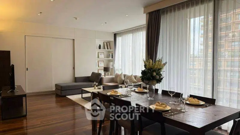 Spacious modern living room with elegant dining area and large windows.