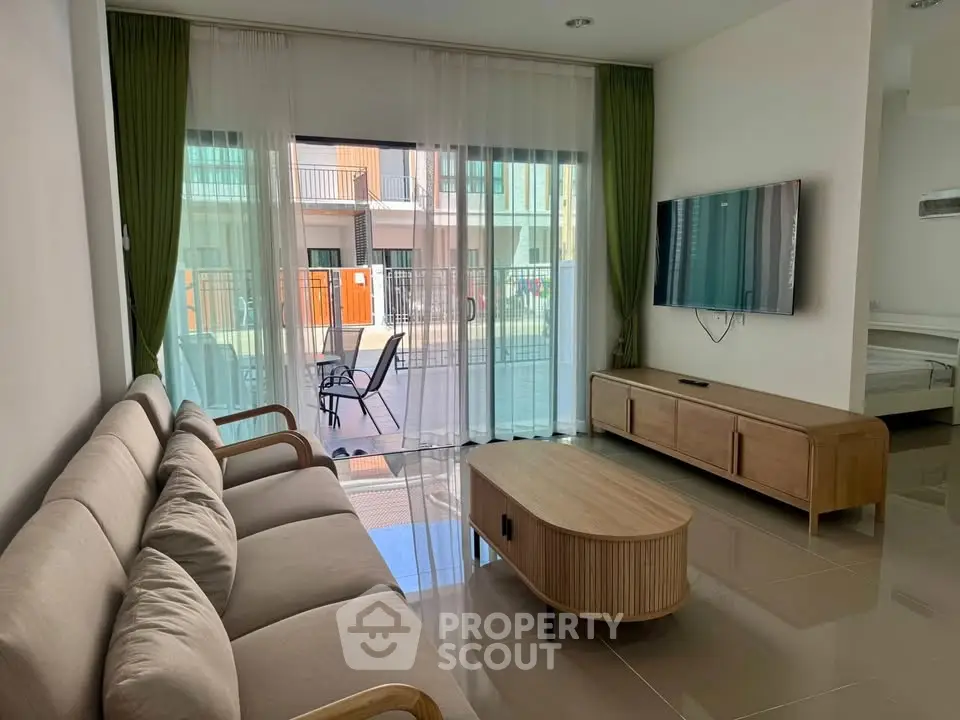 Modern living room with sleek furniture and balcony view