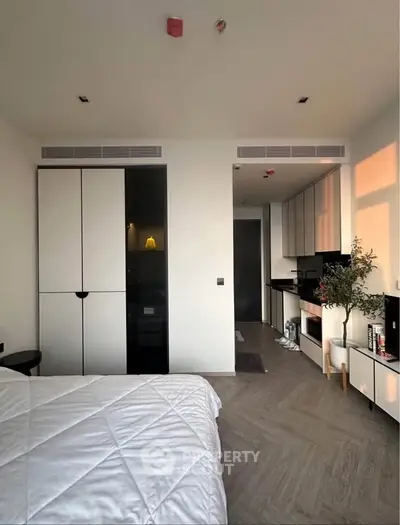 Modern bedroom with integrated kitchen in stylish apartment