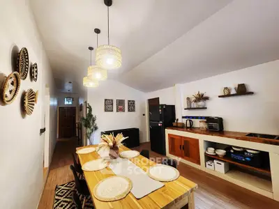 Charming kitchen with open layout and rustic decor, featuring modern appliances and cozy dining area.