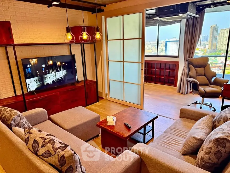 Spacious living room with modern decor and city view, featuring cozy seating and stylish lighting.