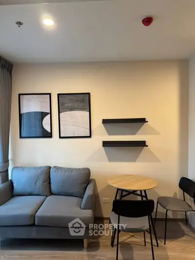 Modern living room with stylish decor, cozy sofa, and dining area in a contemporary apartment.