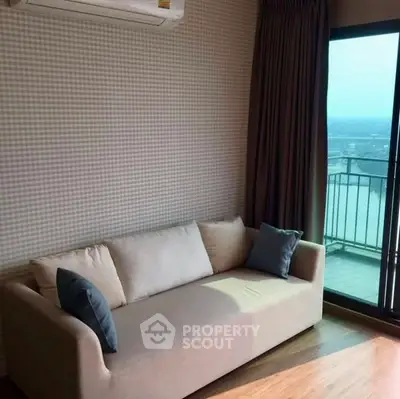 Chic living room with cozy sofa and balcony view in modern apartment