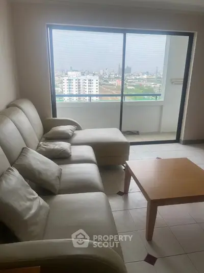 Spacious living room with city view and modern furniture