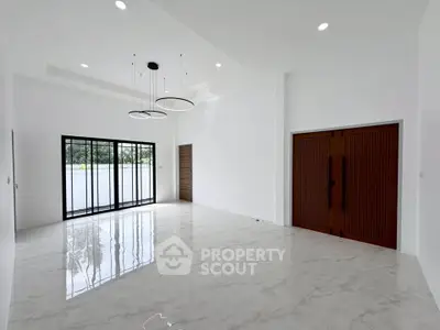 Spacious modern living room with elegant lighting and large windows