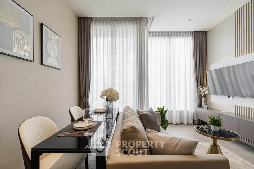 Modern living room with elegant decor, large windows, and stylish furniture in a contemporary apartment.