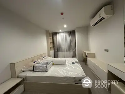 Modern bedroom with built-in furniture and air conditioning in a stylish apartment.