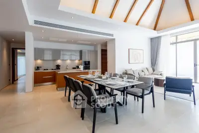 Spacious modern living room with dining area and open kitchen, featuring elegant decor and natural light.