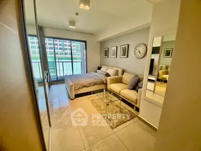 Modern studio apartment with stylish decor and large windows offering natural light.