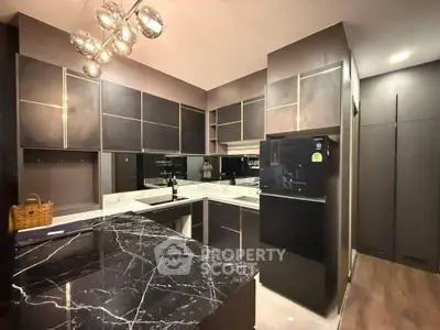 Luxurious modern kitchen with sleek black marble countertops and stylish cabinetry.