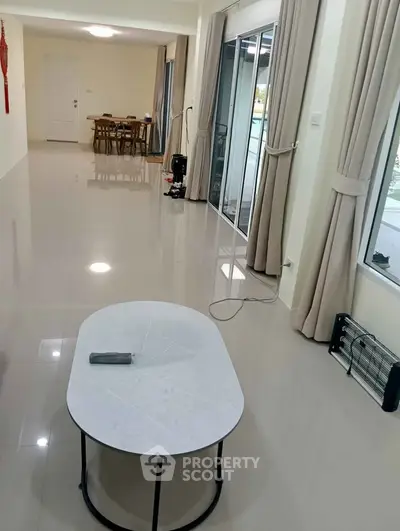 Spacious living room with modern decor and large windows for natural light