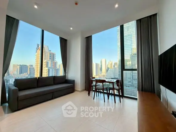 Spacious living room with panoramic city views and modern furnishings.