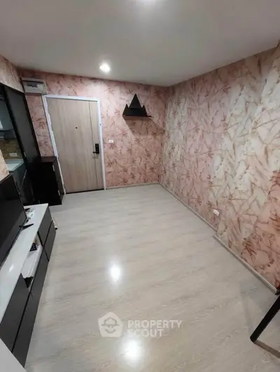 Modern living room with stylish wallpaper and sleek flooring, featuring a minimalist entertainment unit.