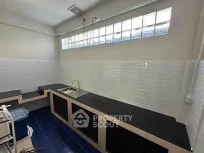 Modern kitchen with sleek countertops and stylish tile backsplash