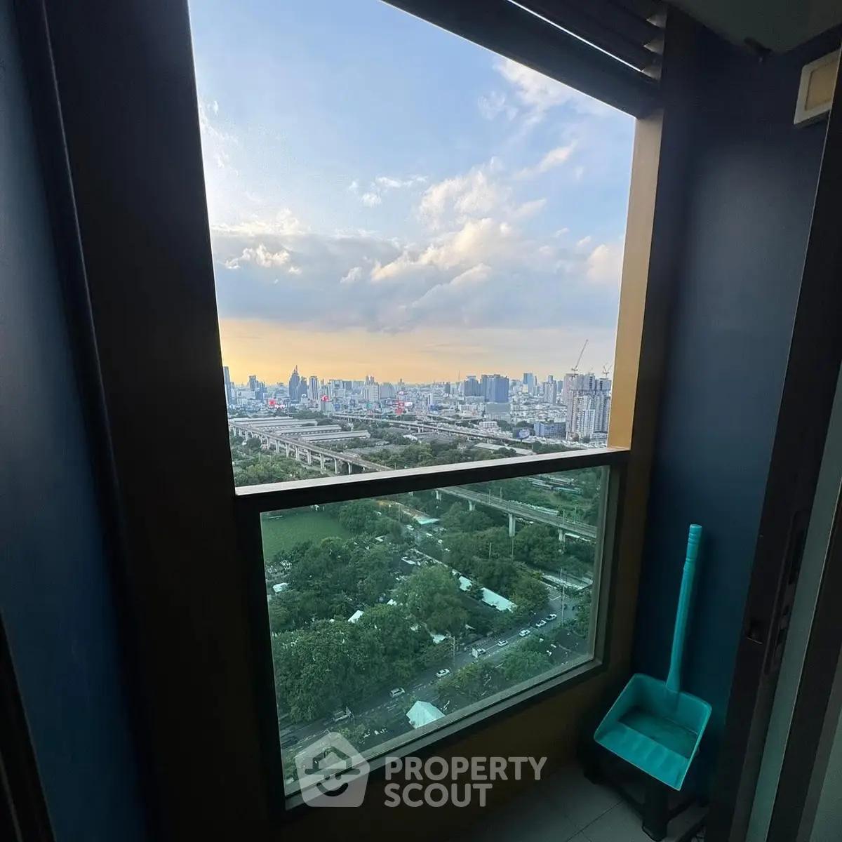 Stunning cityscape view from high-rise balcony at sunset, perfect for urban living.