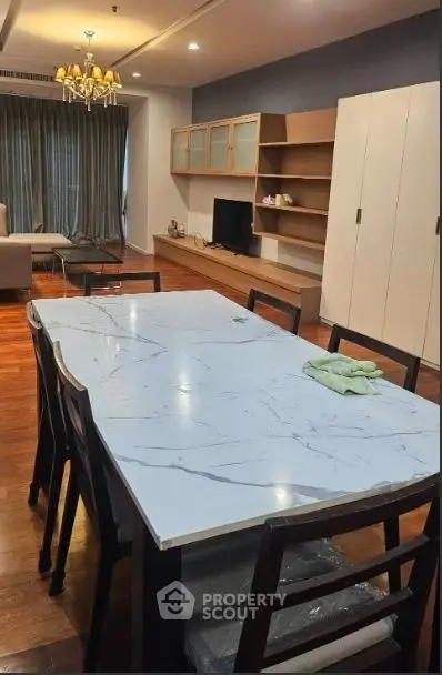 Spacious living room with elegant dining area and modern furnishings, perfect for family gatherings.