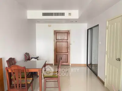 Spacious dining area with wooden furniture and modern decor in a bright apartment.