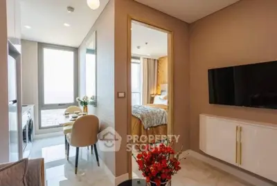 Modern apartment interior with dining area and bedroom view, featuring elegant decor and natural light.