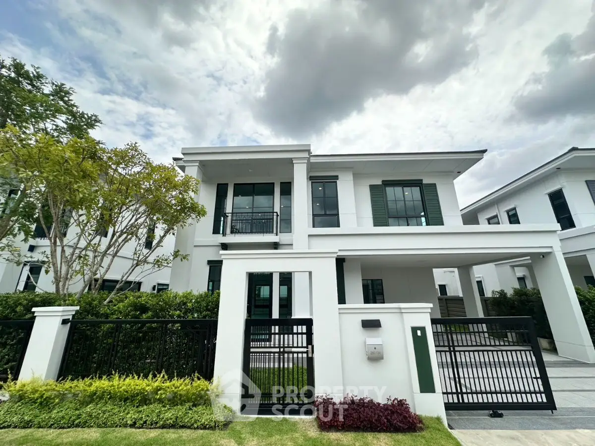 Modern two-story house with sleek design and lush landscaping