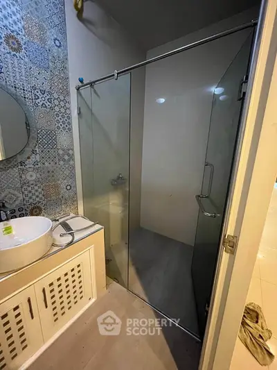 Modern bathroom with glass shower and stylish tile design