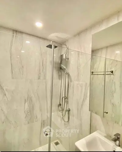 Modern bathroom with sleek shower and elegant marble walls