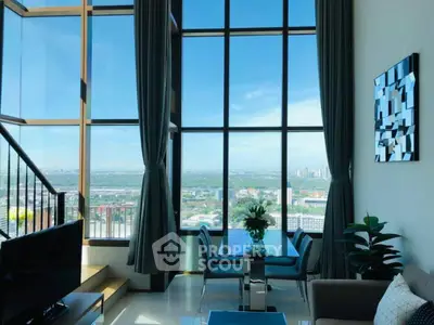 Luxurious high-rise living room with floor-to-ceiling windows and stunning city view.