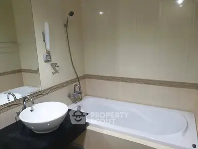 Modern bathroom with elegant bathtub and stylish sink in a contemporary home.