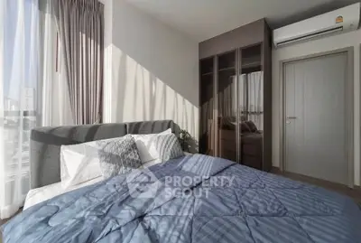 Modern bedroom with stylish decor and ample natural light