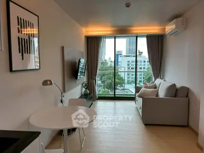 Modern living room with large window and city view, featuring a cozy sofa and stylish decor.