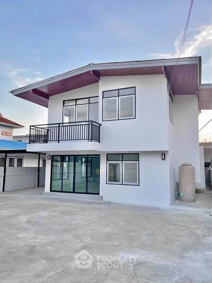 Modern two-story house with spacious driveway and balcony