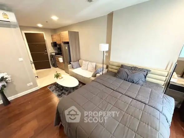 Modern studio apartment with cozy living area and kitchen