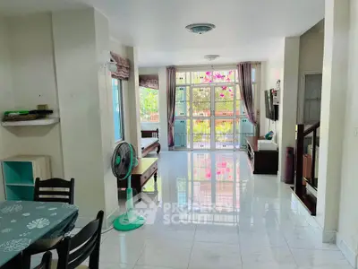 Spacious living room with large windows and natural light